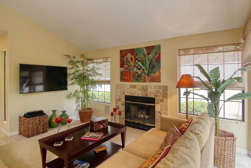 7302 Paseo Verde Carlsbad, CA 92009 - Photo 9 of 24 a living room with furniture a flat screen tv and a fireplace