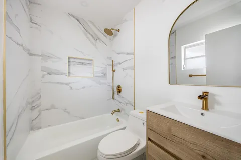 a bathroom with a sink a toilet and a bathtub