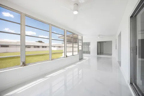 an empty room with windows and entrance