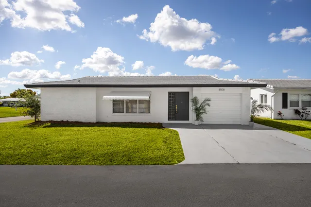 a view of backyard with outdoor seating and green space