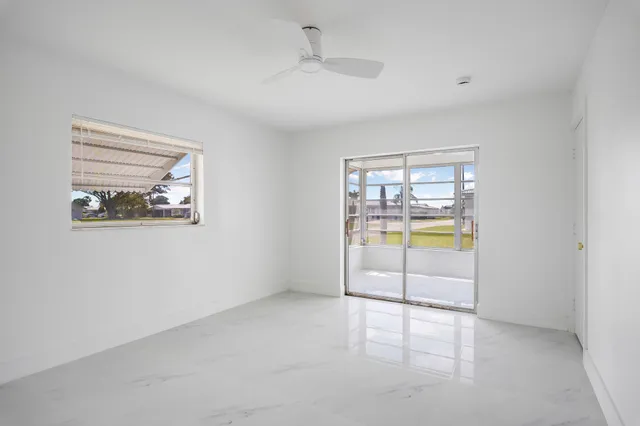 an empty room with a fireplace and a large window