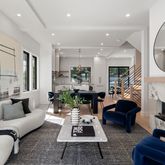a living room with furniture a fireplace a rug and a large mirror