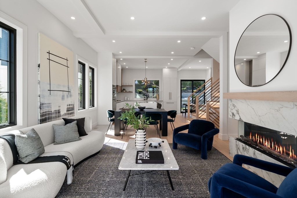 a living room with furniture a fireplace a rug and a large mirror