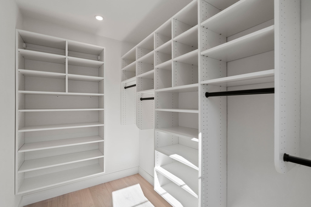 49 Ripley Street Newton, MA 02459 - Photo 16 of 32 a view of walk in closet with empty racks