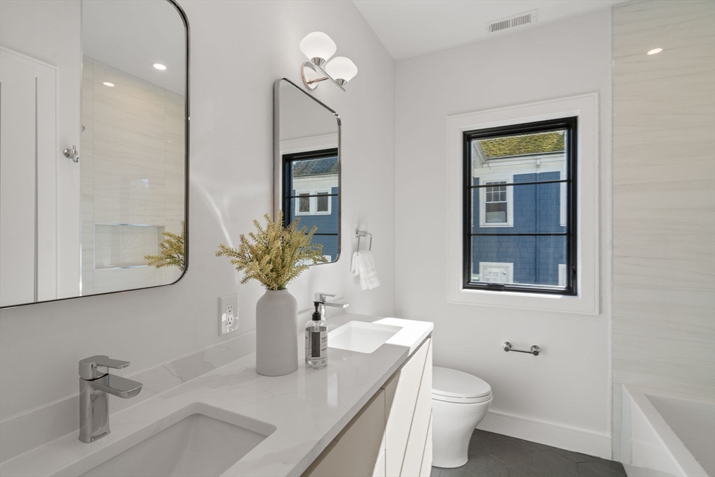 49 Ripley Street Newton, MA 02459 - Photo 19 of 32 a bathroom with a toilet a sink and mirror