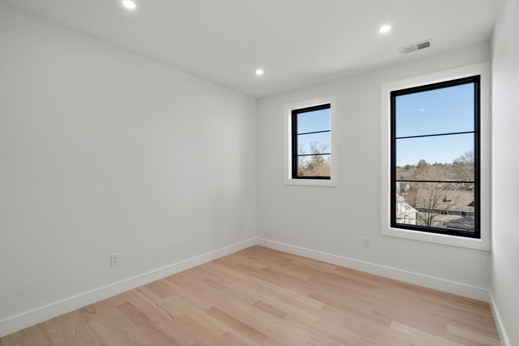 49 Ripley Street Newton, MA 02459 - Photo 20 of 32 an empty room with windows and closet