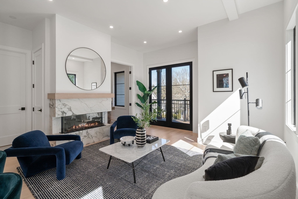 49 Ripley Street Newton, MA 02459 - Photo 2 of 32 a living room with furniture and a large mirror