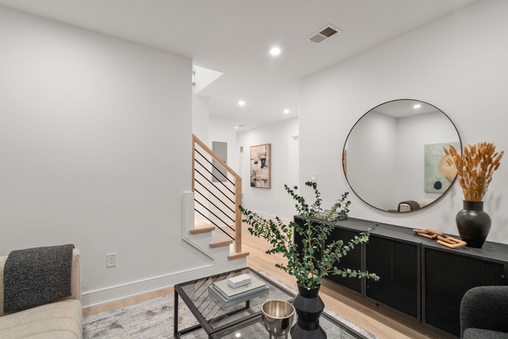 49 Ripley Street Newton, MA 02459 - Photo 24 of 32 a living room with furniture and a potted plant