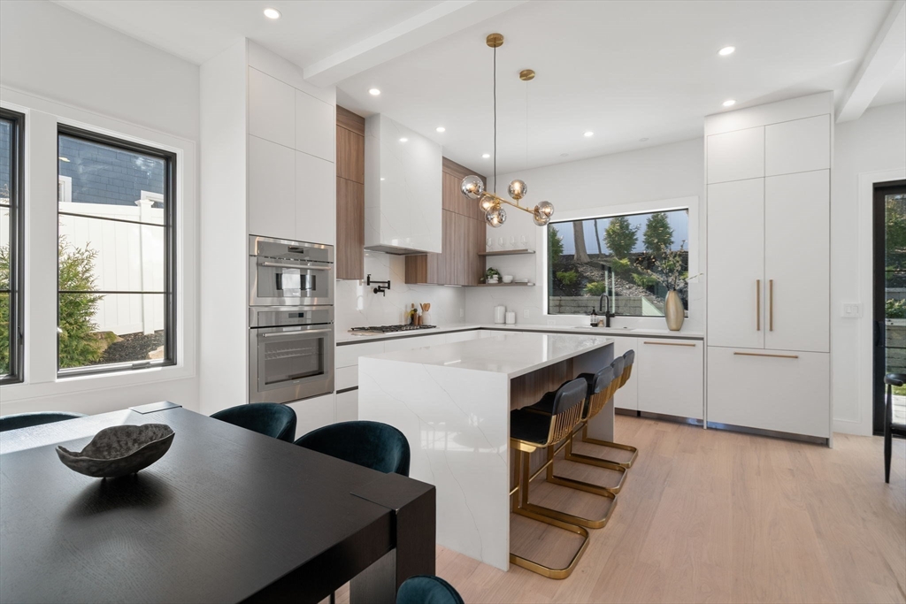 49 Ripley Street Newton, MA 02459 - Photo 4 of 32 a kitchen with counter top space appliances and windows