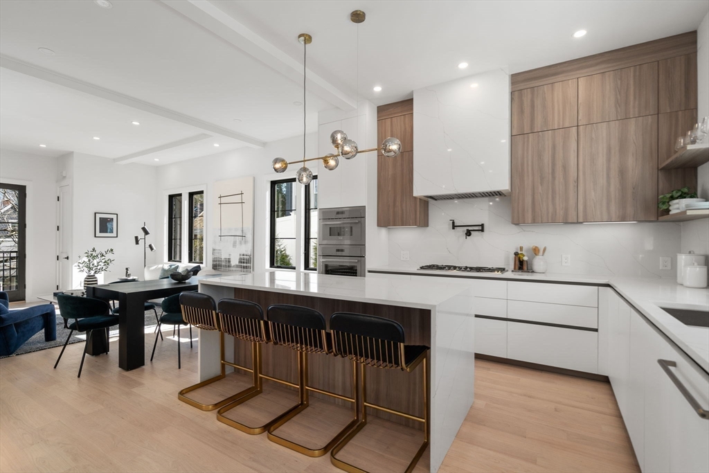 49 Ripley Street Newton, MA 02459 - Photo 5 of 32 a kitchen with a sink and chairs