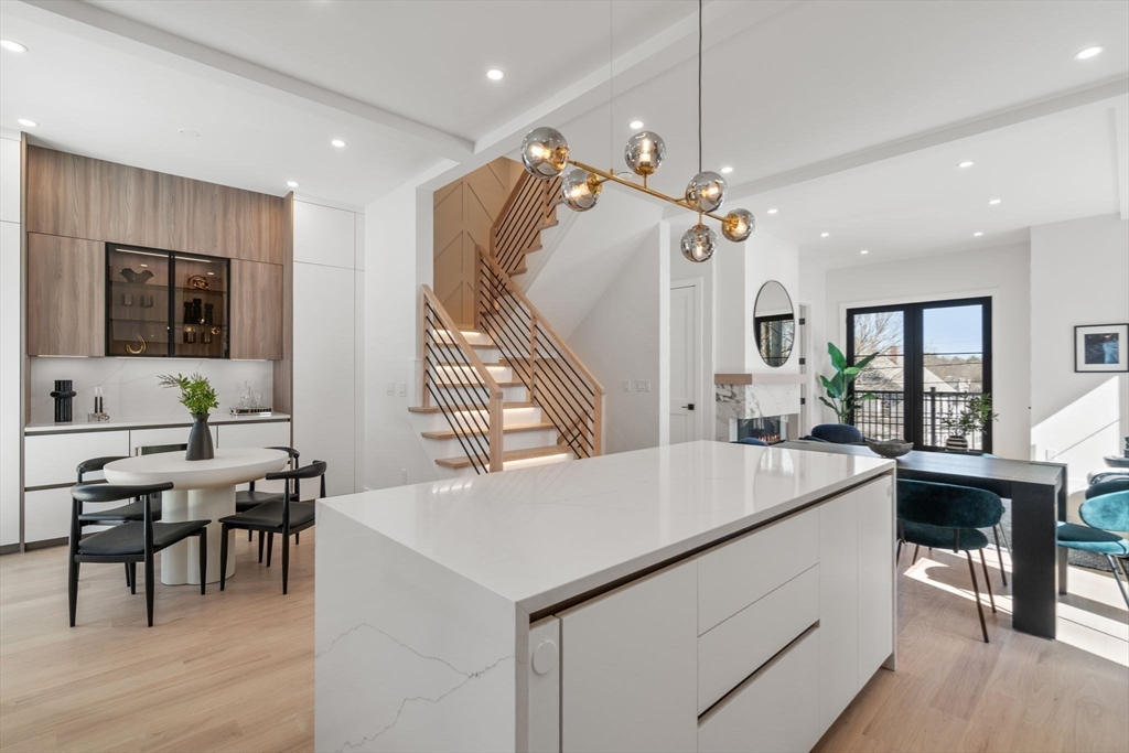 49 Ripley Street Newton, MA 02459 - Photo 8 of 32 a living room with furniture a dining table and a wooden floor