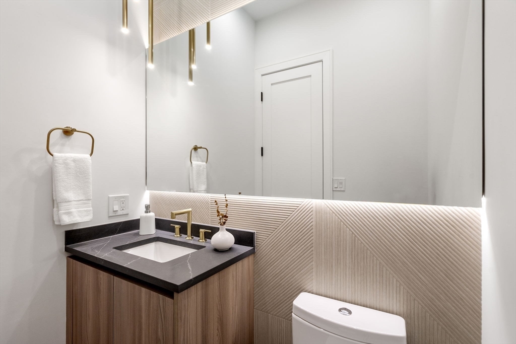 49 Ripley Street Newton, MA 02459 - Photo 10 of 32 a bathroom with a sink and a mirror