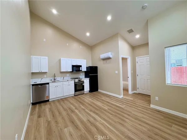 a large kitchen with kitchen island a sink stainless steel appliances and cabinets