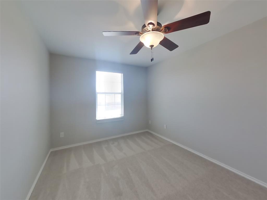 216 Rambling Way Forney, TX 75126 - Photo 11 of 22 an empty room with chandelier fan and windows