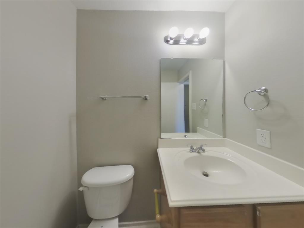 216 Rambling Way Forney, TX 75126 - Photo 13 of 22 a bathroom with a toilet sink and mirror