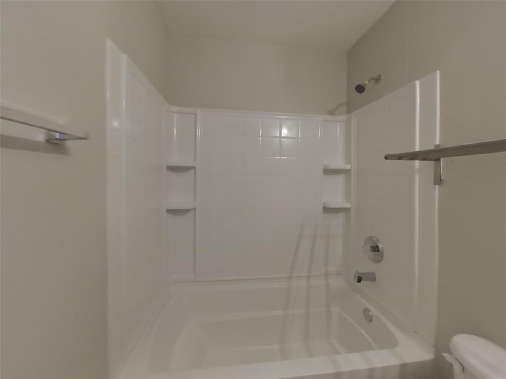 216 Rambling Way Forney, TX 75126 - Photo 16 of 22 a bathroom with a bathtub and a shower
