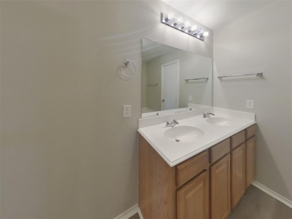 216 Rambling Way Forney, TX 75126 - Photo 8 of 22 a bathroom with a sink and a mirror