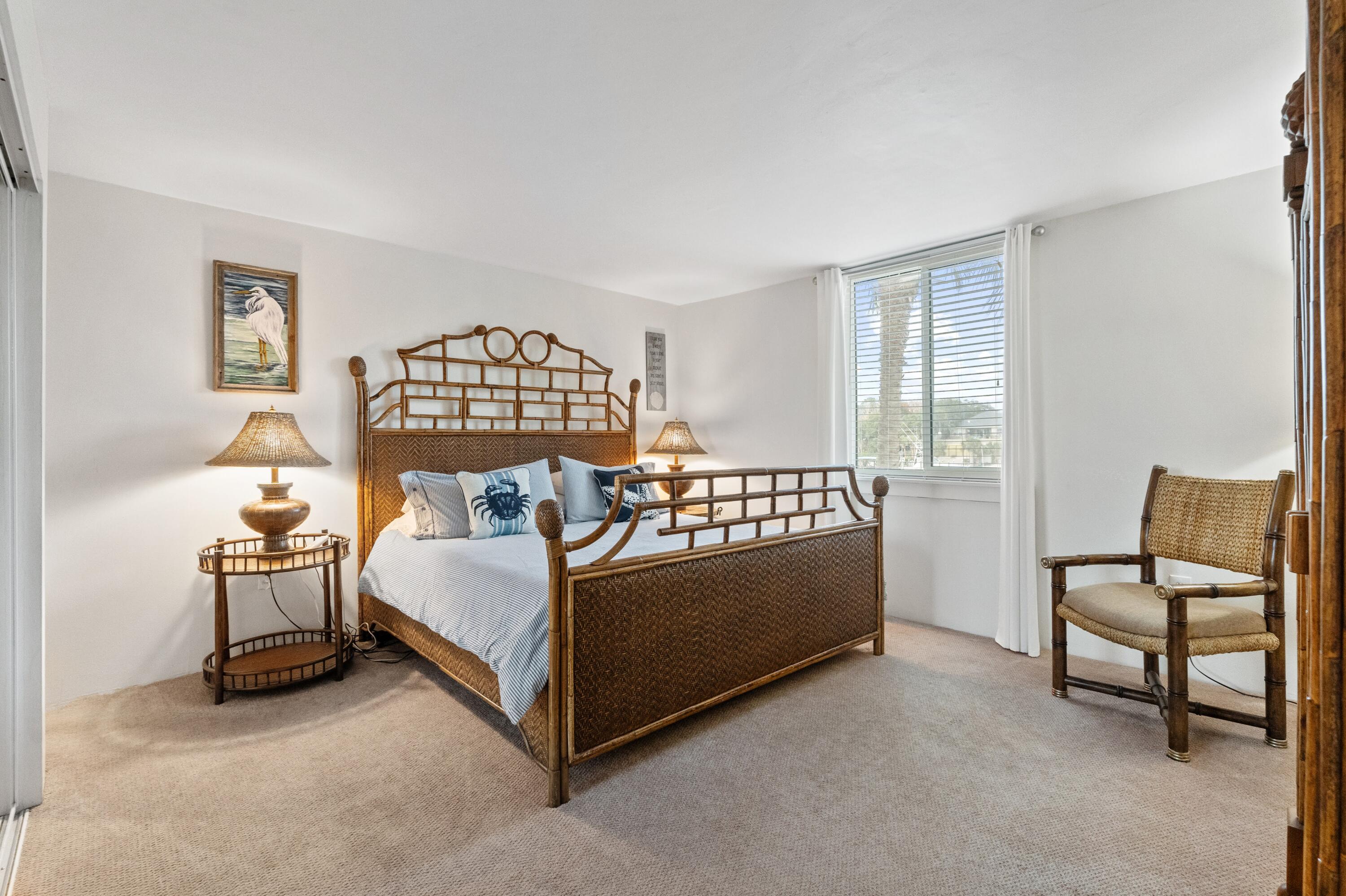 30 Moreno Point Road, Unit 201C Destin, FL 32541 - Photo 20 of 52 a bed room with a bed and a chair