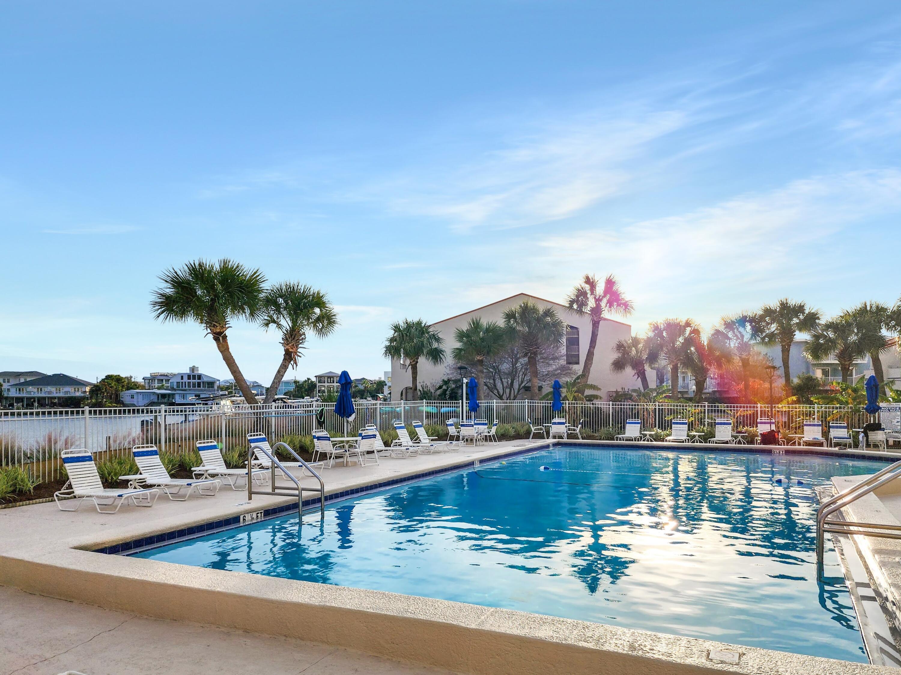 30 Moreno Point Road, Unit 201C Destin, FL 32541 - Photo 7 of 52 a view of swimming pool with outdoor seating and lake view