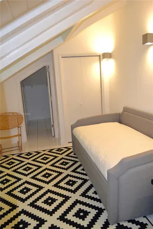 a bedroom with a bed and a mirror