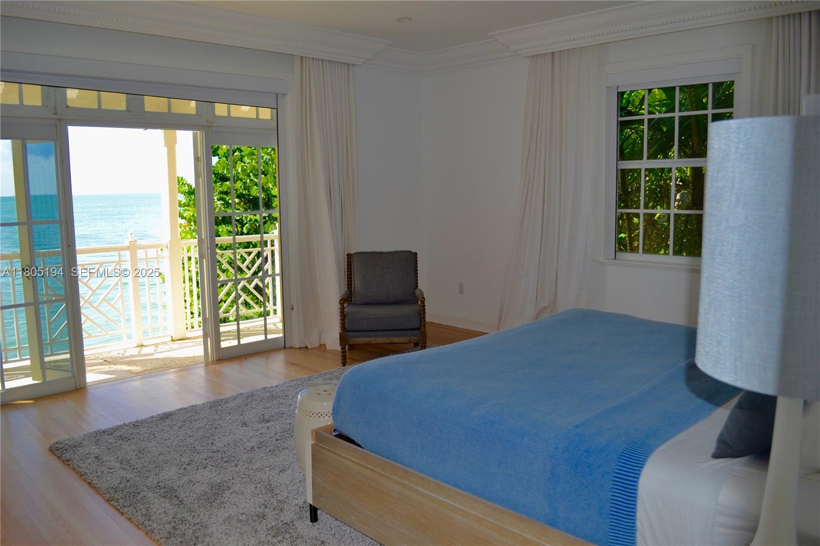 710 South Mashta Drive Key Biscayne, FL 33149 - Photo 5 of 13 a bed sitting in a bedroom next to a window