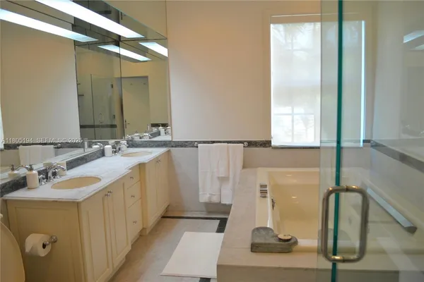 a bathroom with a double vanity sink and a mirror