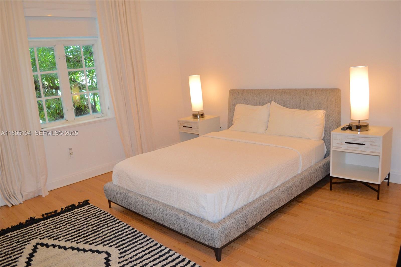 710 South Mashta Drive Key Biscayne, FL 33149 - Photo 8 of 13 a large bed sitting in a bedroom next to a window