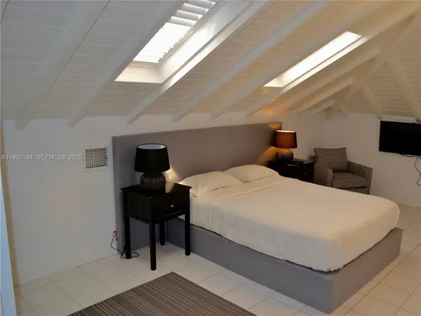 a large white bed in a white room