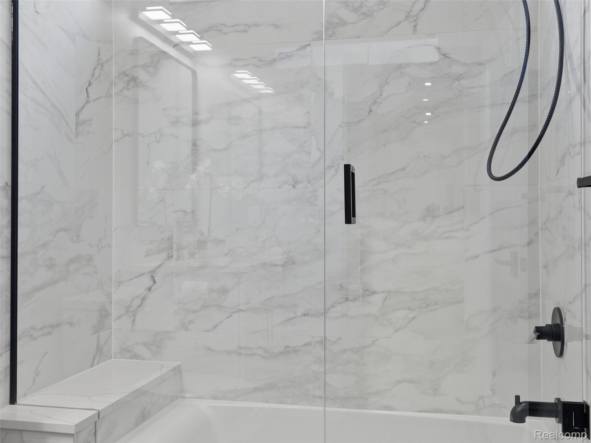 77850 Angling Road Richmond, MI 48062 - Photo 29 of 54 Shower-tub combination featuring a clear glass enclosure with matte black hardware