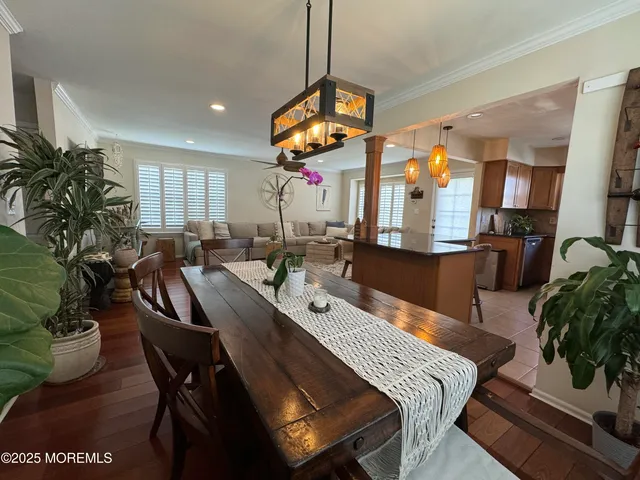 a view of a dining room with furniture and chandelier