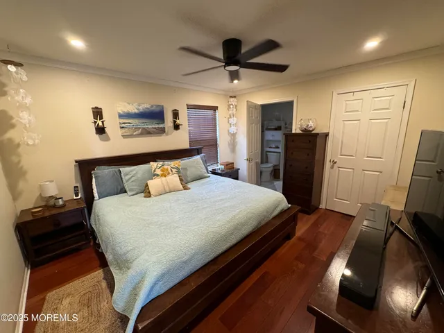 a bedroom with a bed and a refrigerator
