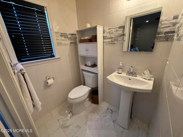 a bathroom with a sink toilet and mirror