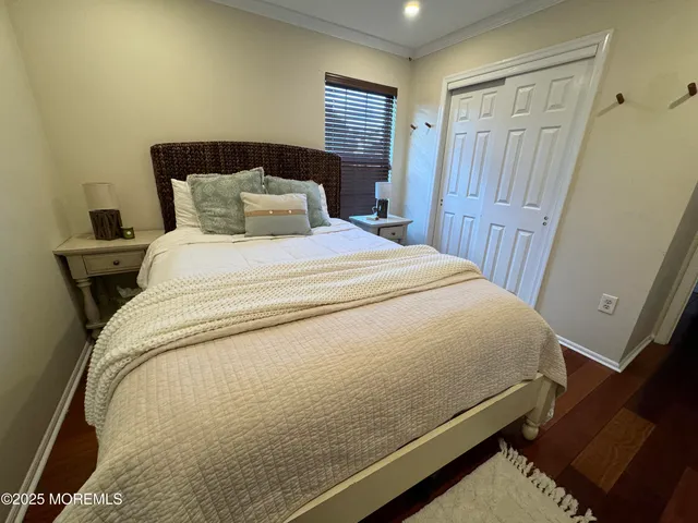 a bed sitting in a bedroom next to a window