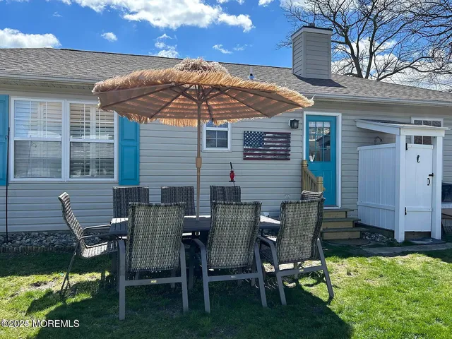 a view of backyard of house with seating space