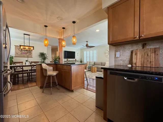 a kitchen with granite countertop a sink a counter top space and appliances