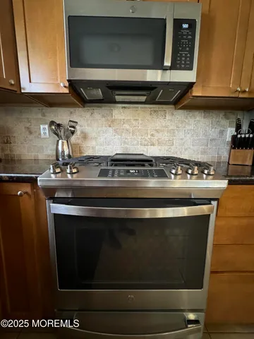a stove top oven sitting inside of a kitchen