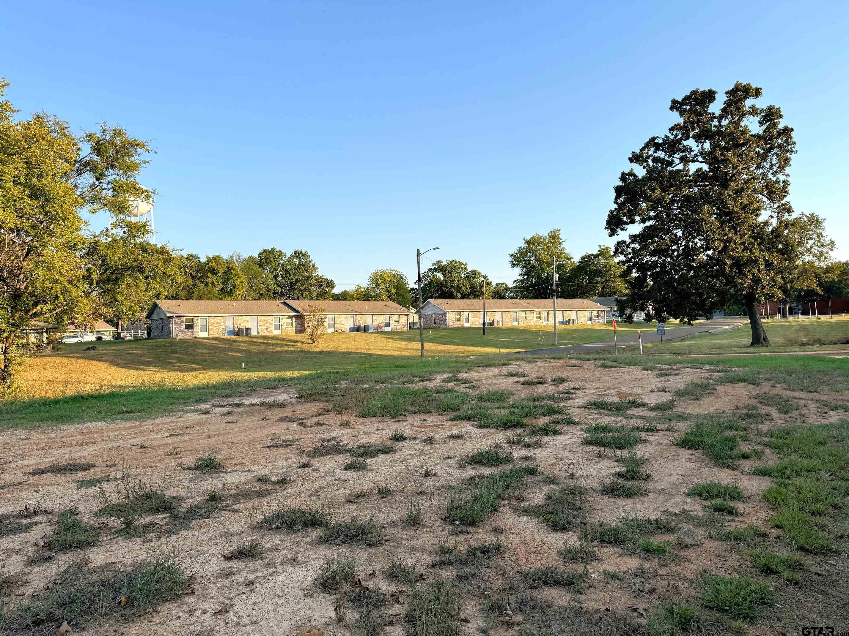 700 West Cash Street Mount Pleasant, TX 75455 - Photo 4 of 5 a view of a golf course with a lake
