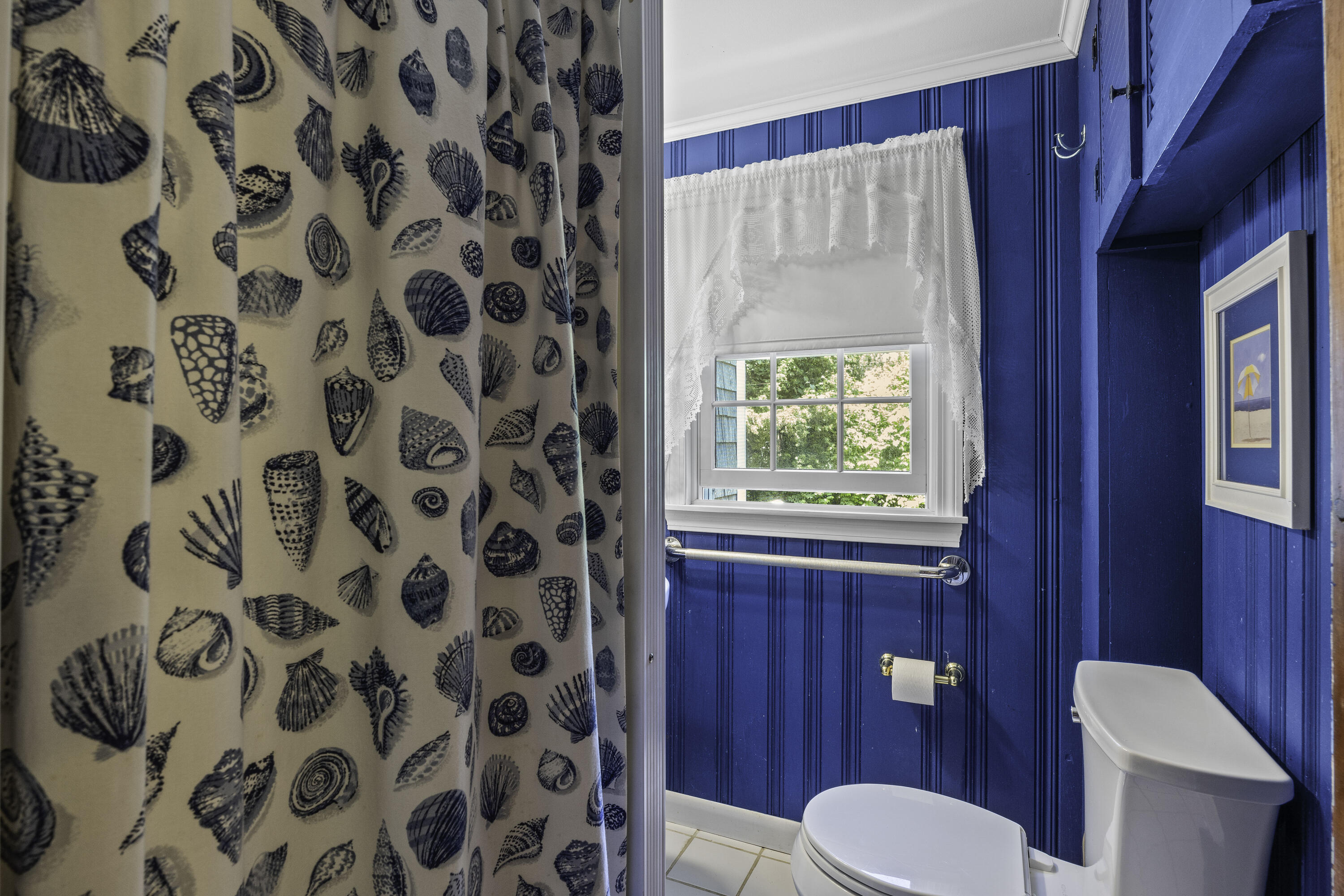 15 Doane Way Orleans, MA 02653 - Photo 16 of 54 a bathroom with a toilet and a shower curtain