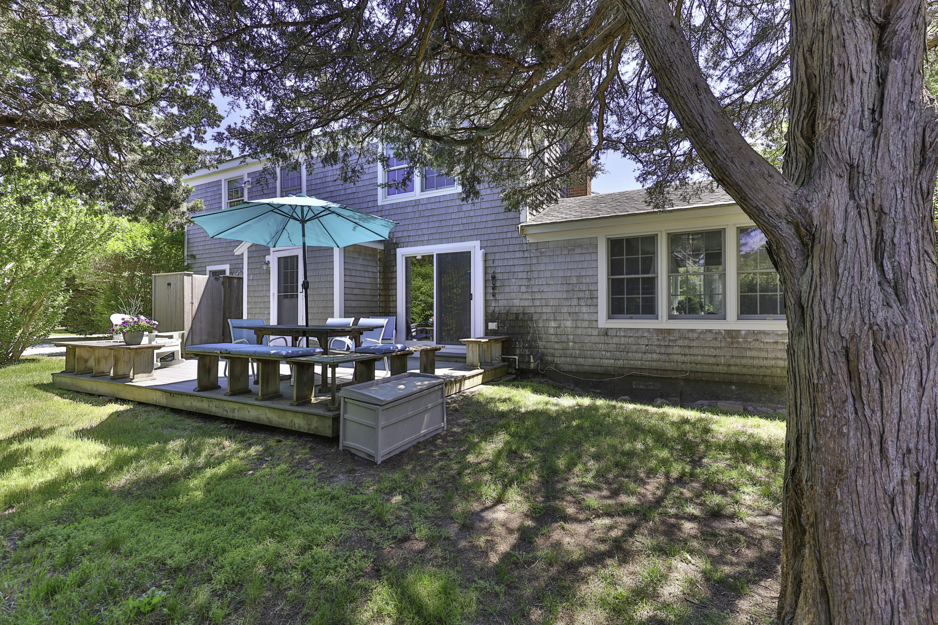 15 Doane Way Orleans, MA 02653 - Photo 32 of 54 a front view of a house with swimming pool table and chairs