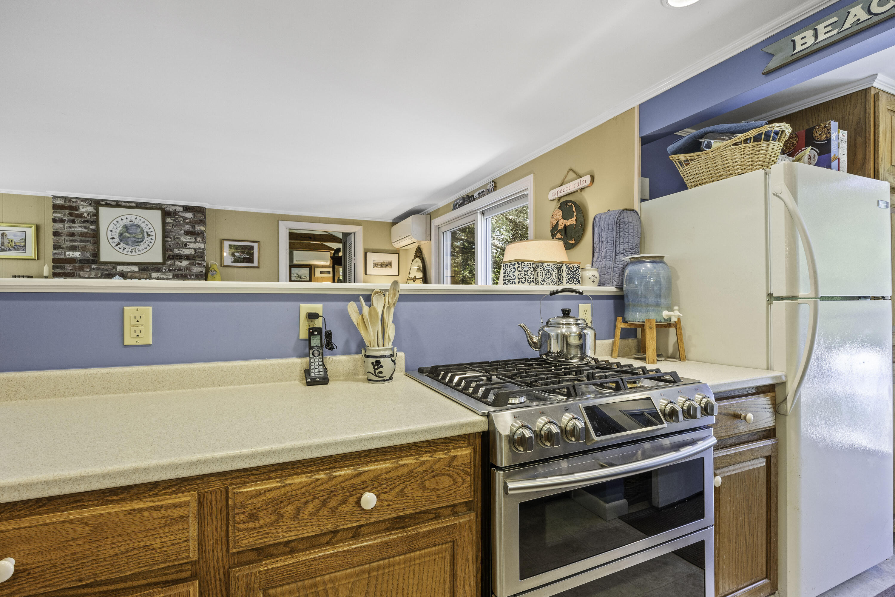 15 Doane Way Orleans, MA 02653 - Photo 10 of 54 a kitchen with stainless steel appliances a stove a microwave and a refrigerator