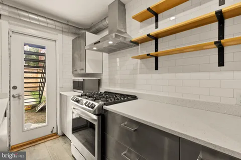 a kitchen with stainless steel appliances a stove and a refrigerator