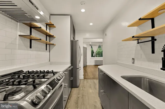a kitchen with a sink and a stove top oven
