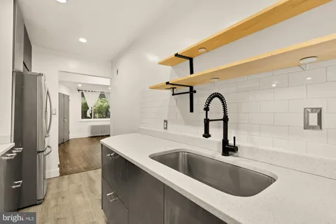 a kitchen with a sink and a refrigerator