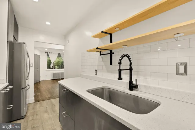 a kitchen with a sink and a refrigerator