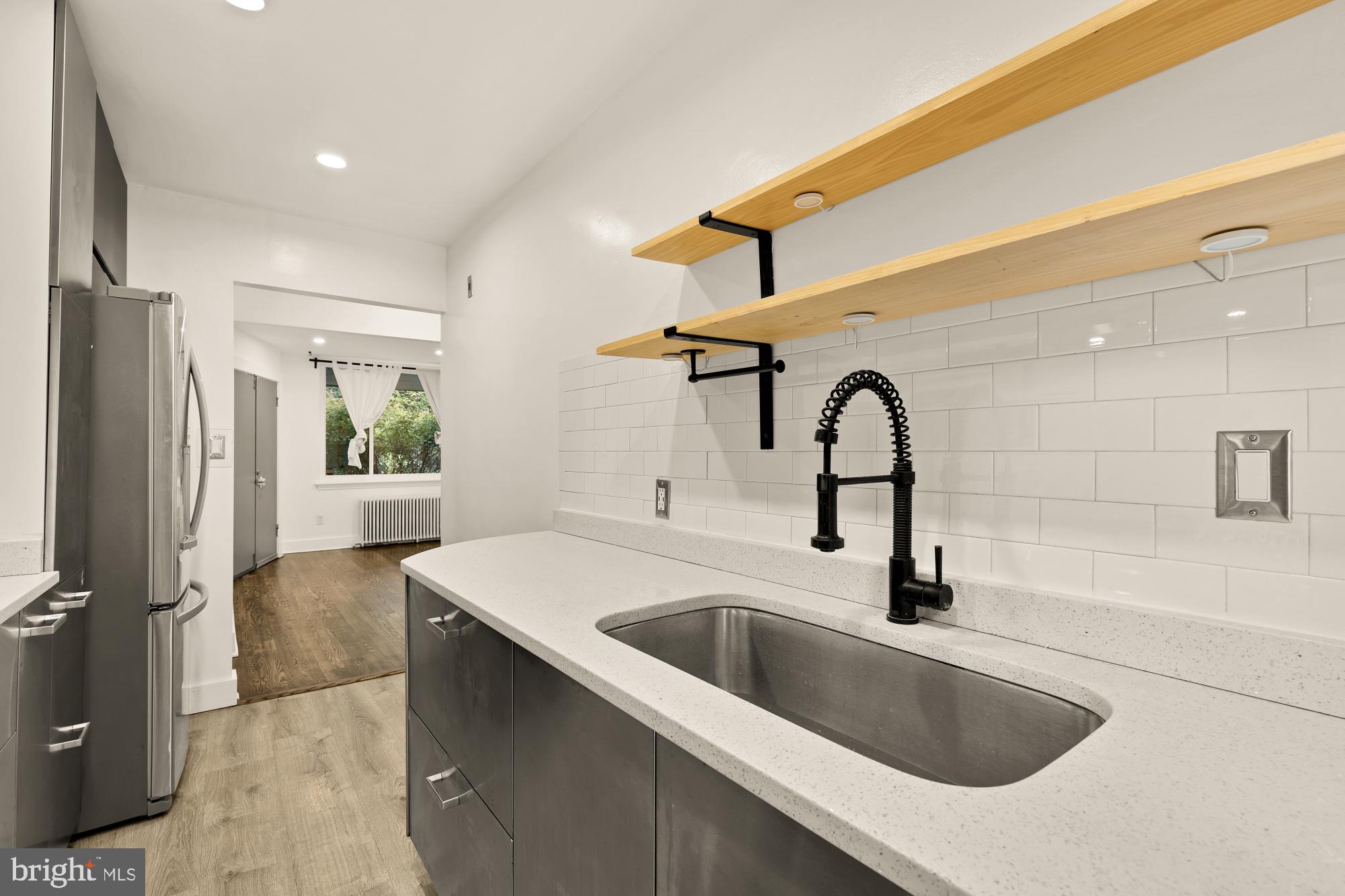 215 Hawaii Avenue Northeast Washington, DC 20011 - Photo 19 of 45 a kitchen with a sink and a refrigerator