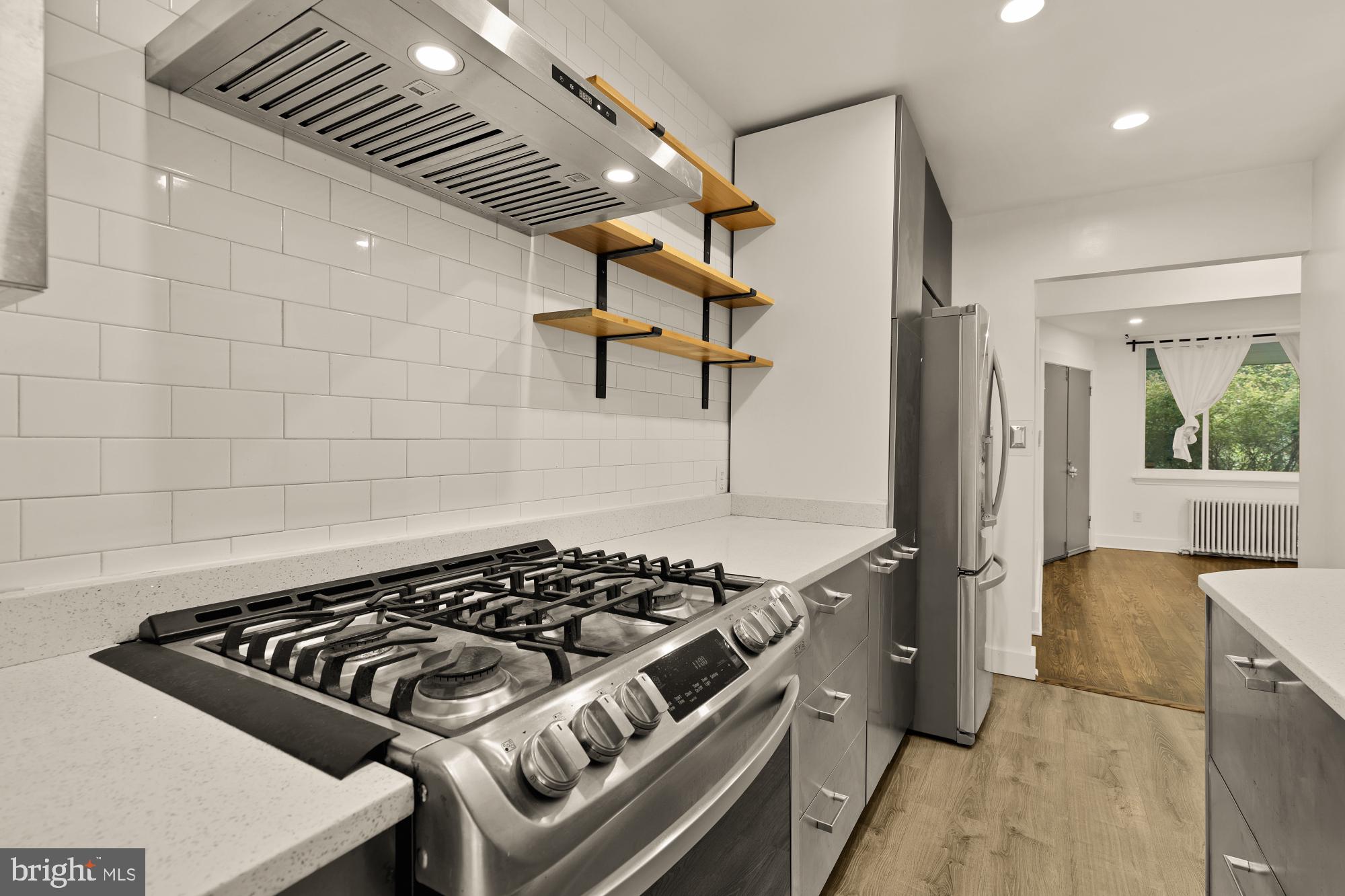 215 Hawaii Avenue Northeast Washington, DC 20011 - Photo 20 of 45 a kitchen with a stove and a wooden floor