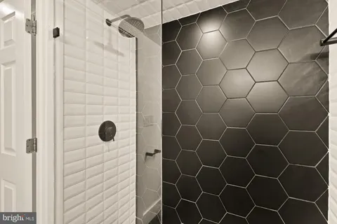 a bathroom with a shower and a glass door shower