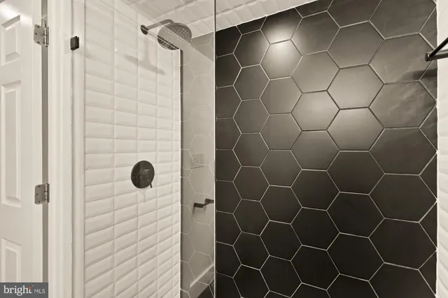 a bathroom with a shower and a glass door shower