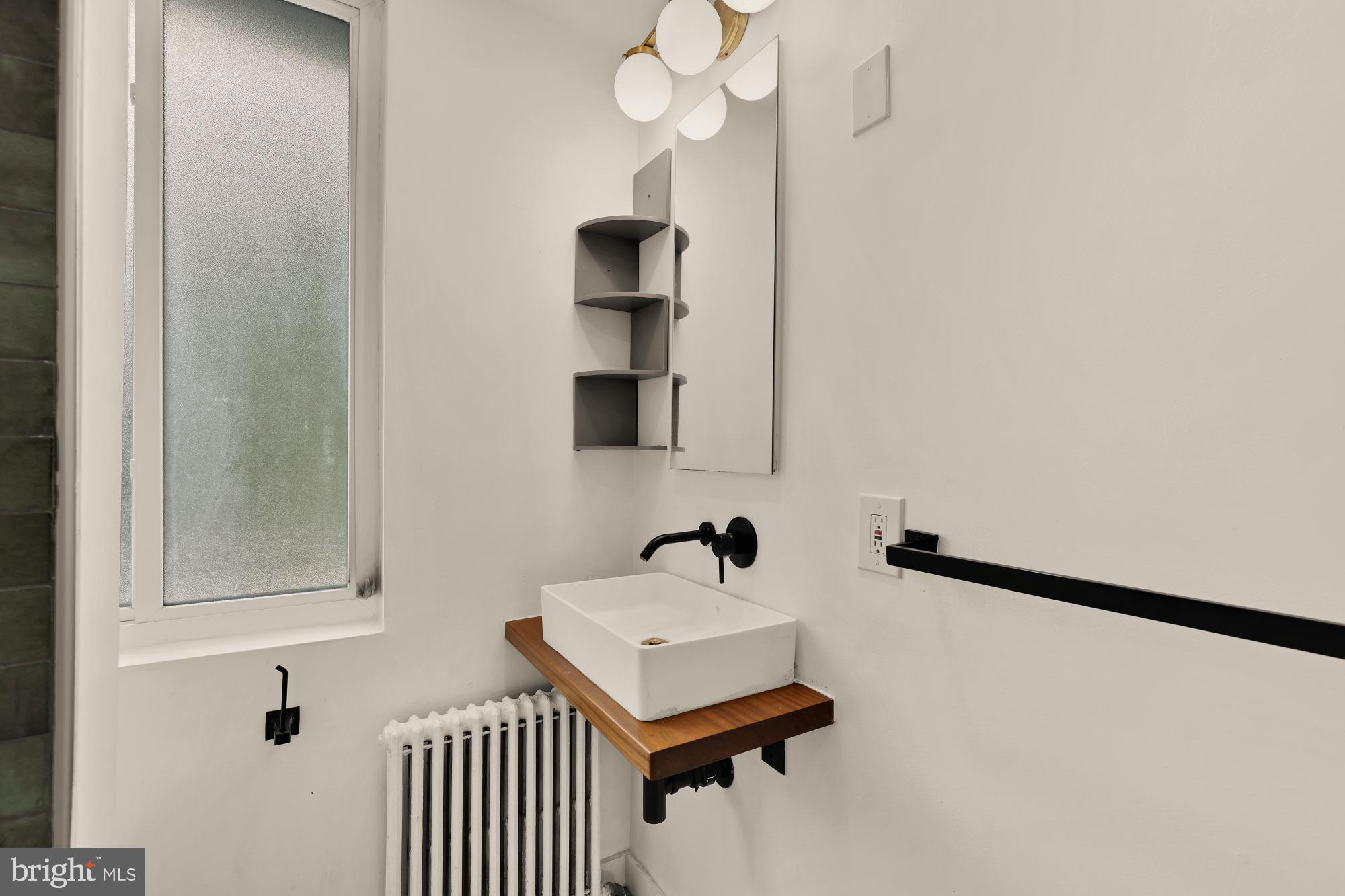 215 Hawaii Avenue Northeast Washington, DC 20011 - Photo 30 of 45 a bathroom with a sink and a mirror