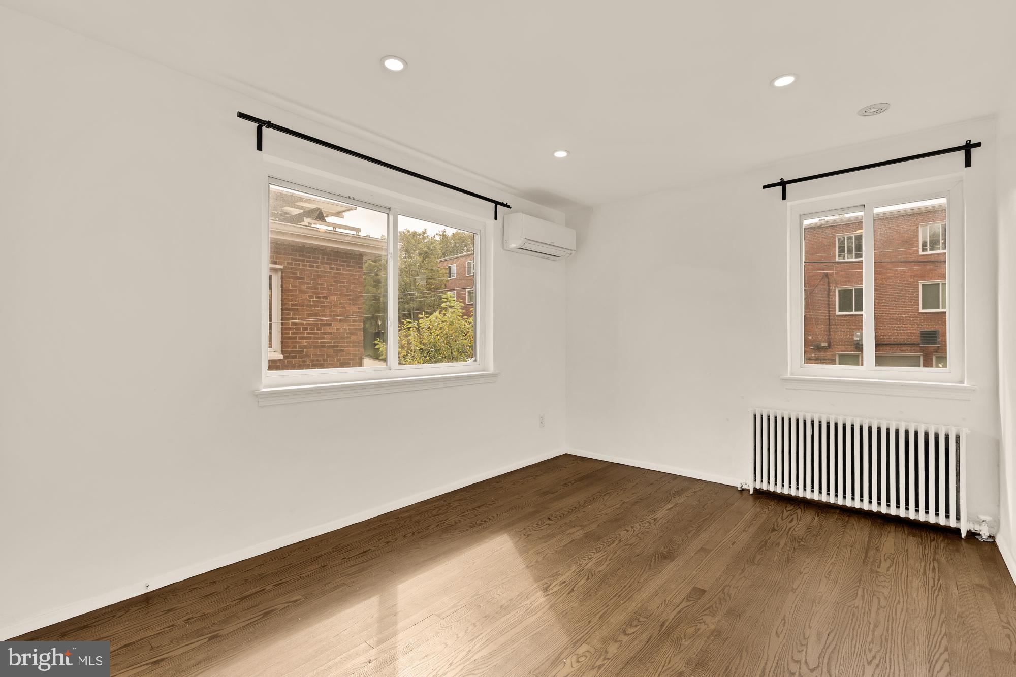 215 Hawaii Avenue Northeast Washington, DC 20011 - Photo 31 of 45 a view of an empty room with wooden floor and a window